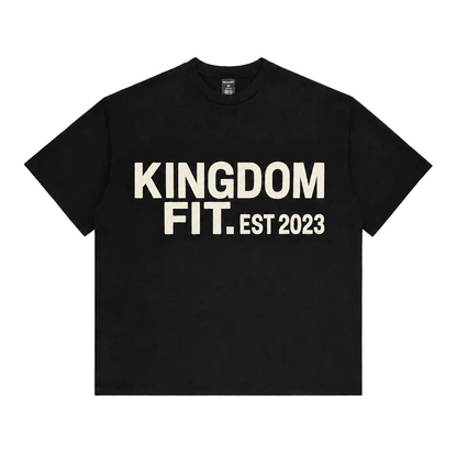 A black short-sleeve crewneck T-shirt with 'KINGDOM FIT. EST 2023' printed in bold cream-colored letters across the chest, displayed flat against a light gray background.